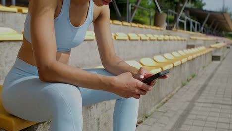 woman using phone at a stadium