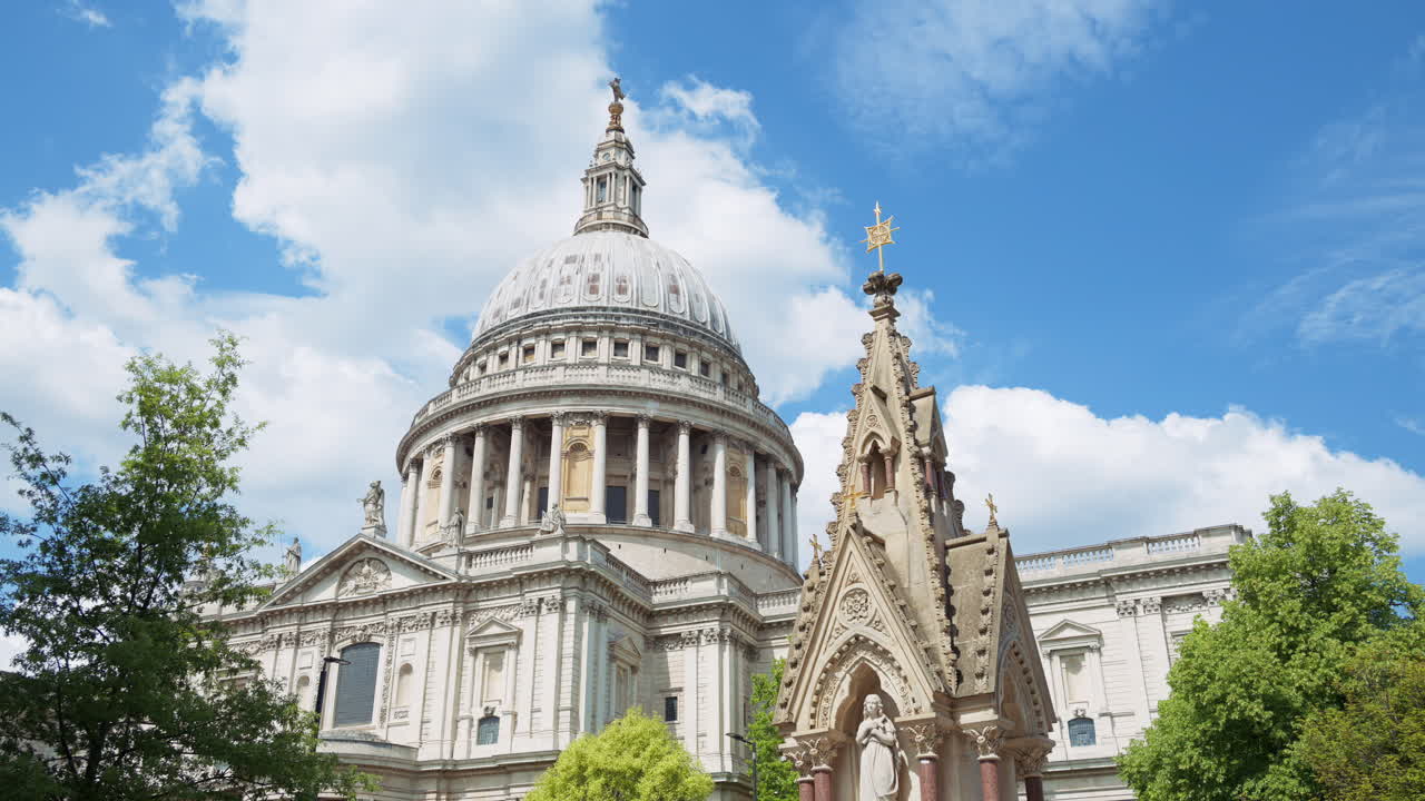 The Dome of St. Paul's Cathedral rising above the trees with a clear blue sky in the background in London, England