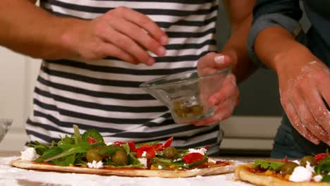 lose-up-view-of-a-couple-preparing-pizza