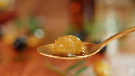 green olive on spoon