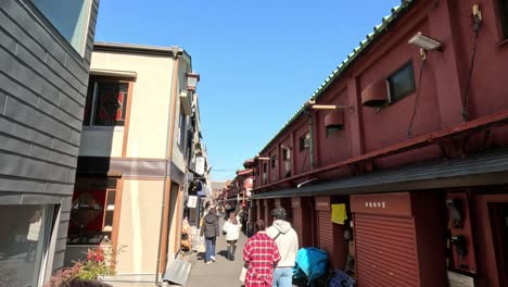 people walking in a narrow, vibrant street market