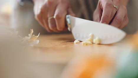 Cooking,-garlic-and-hands-of-woman-with-knife