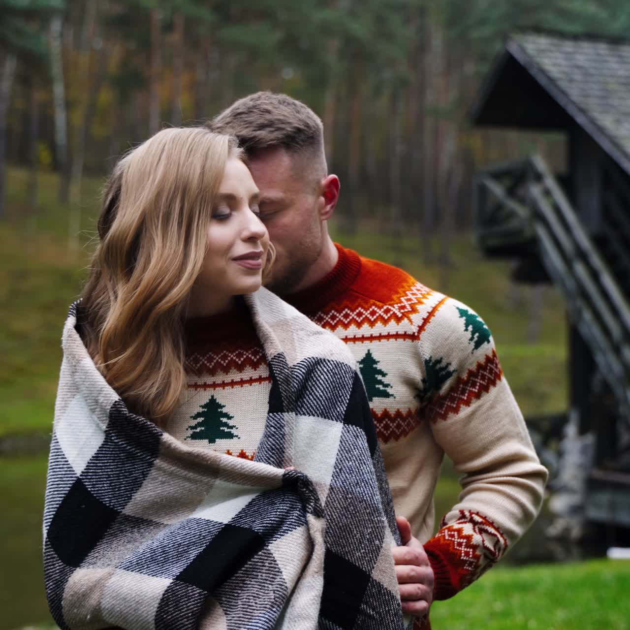 Loving couple in the village. Young man standing close to his girlfriend outdoors. Romantic couple enjoys the time together on nature background.