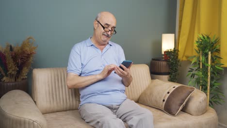 Sehnsüchtig-Betrachtet-Der-Alte-Mann-Das-Foto-Am-Telefon.