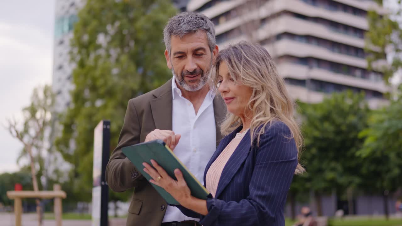 Business people discussing work on a tablet