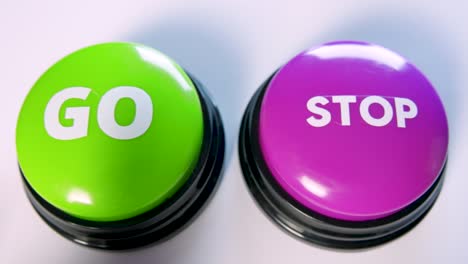 choosing between go and stop button. woman can't decide, she is doubtful. playing a fun game. turn on or off. pause or start an action or process. motivation to begin, make the first move. ready to go