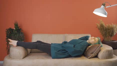 young woman lying on the sofa is resting.