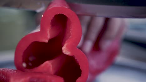 cutting red peppers and onions with a knife