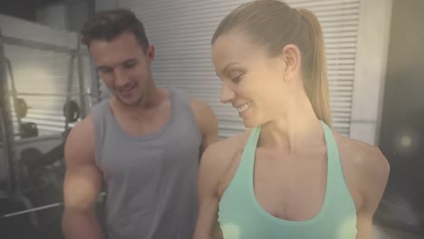 animation of light spots over diverse people exercising at gym