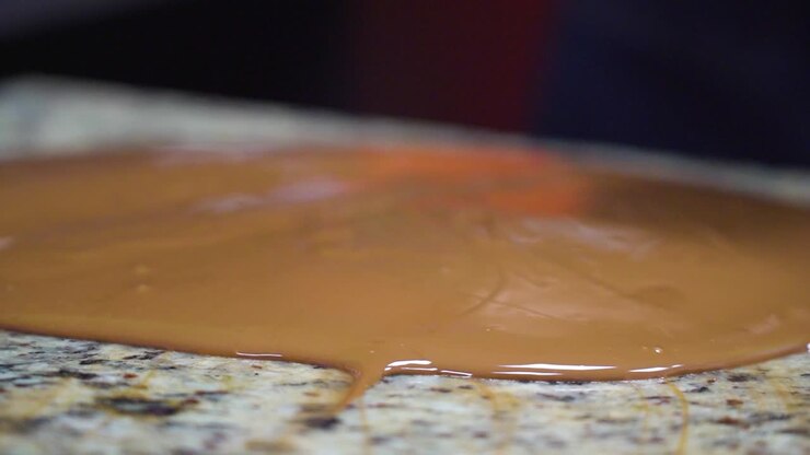 Close-up of chocolate being spread with a spatula during preparation