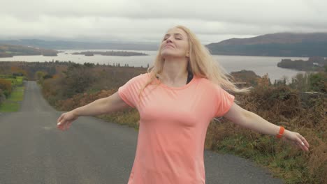 joyful ukrainian woman twirling in front of scenic lake view