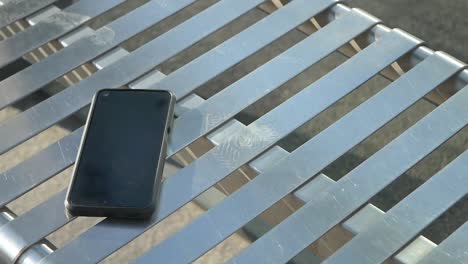 smartphone on a metal bench
