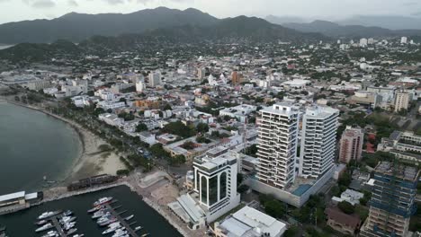 aerial santa marta city marina, colombia, aerial view of sailboats, breakwater and cityscape skyline sierra nevada mountain and luxury hotel in the rodadero