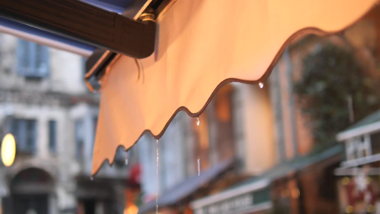 Rain Dripping from an Awnings in a City Street