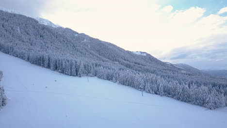 Panoramic-wintry-aerial-view-of-Dolomites-mountain-forest,-captivating-scenery