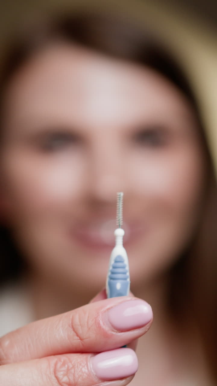 Woman demonstrating an interdental brush