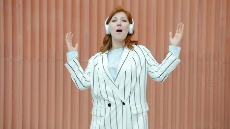 woman dancing to music with headphones