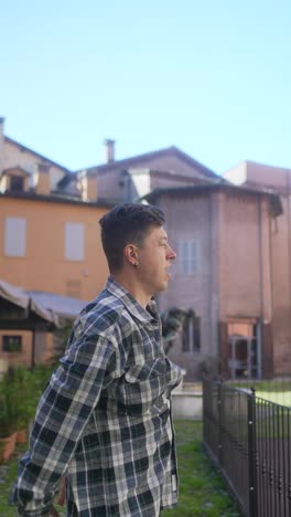 young man posing outdoors in city