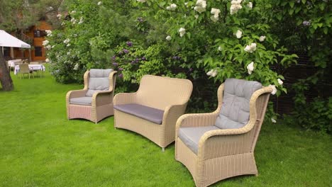 wicker patio furniture in a garden setting