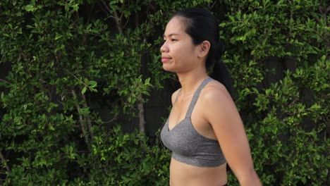 thai woman woman exercising doing cross arm and triceps stretch