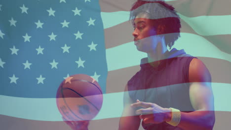 Animation-of-american-flag-over-african-american-male-basketball-player-spinning-ball