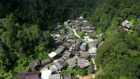 drone reveal of beautiful hidden village deep in south east asian jungle