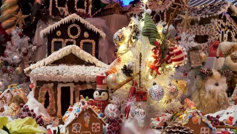 christmas decorations arrangement, christmas traditions with gingerbread houses, candy's, toys, christmas tree and lights.