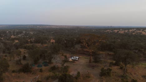 Sunrise-near-a-river-and-campsite-in-Ol-Pejeta,-Kenya