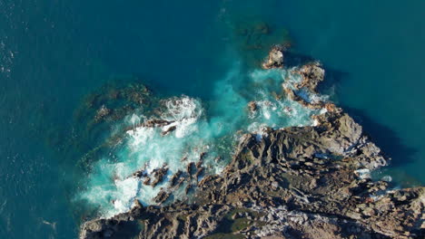 Aerial-view-of-the-waves-breaking-on-the-volcanic-rock-formation-on-the-coast-of-the-island-of-Tenerife,-Canary-Islands,-Spain