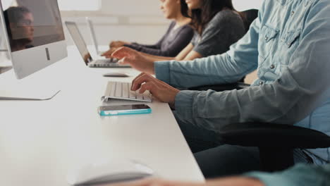 Close-up-hands-typing-on-keyboards-in-office