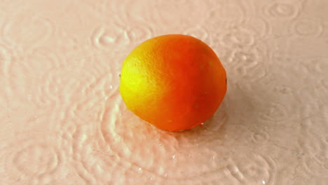 Orange-spinning-on-wet-white-surface