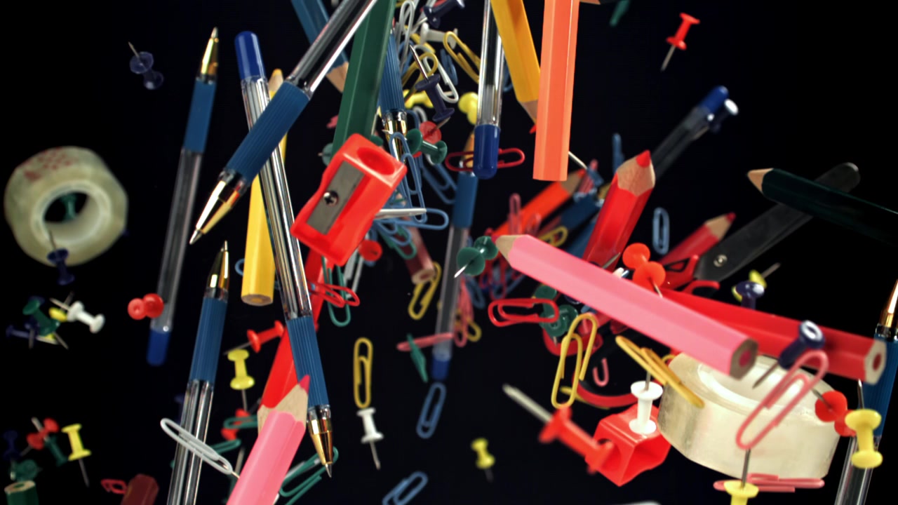 Colorful Stationery and Office Supplies Floating on Black Background