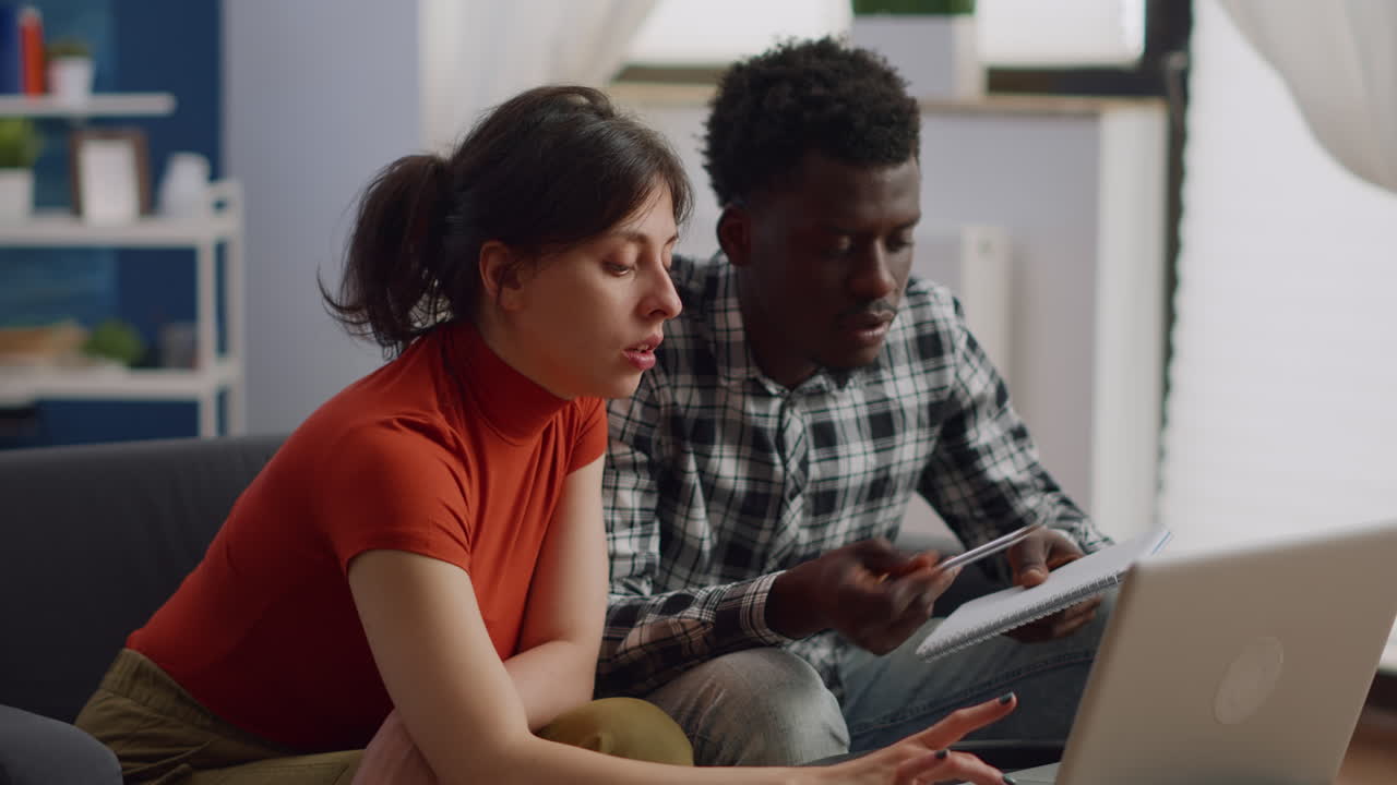 Married interracial people checking taxes payment and money