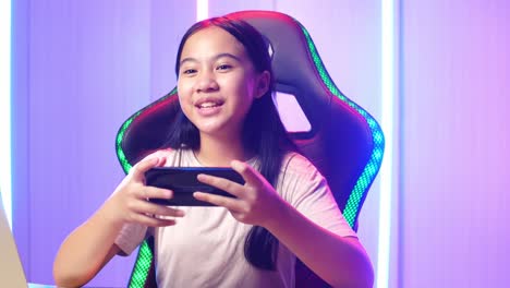 asian kid girl holding mobile phone and talking to camera while live stream