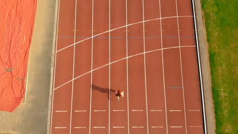 Female-athletic-running-on-sports-track-4k