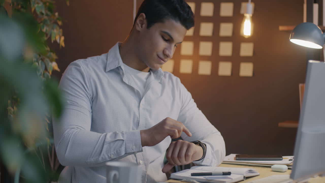 Man Checking Smartwatch in Office