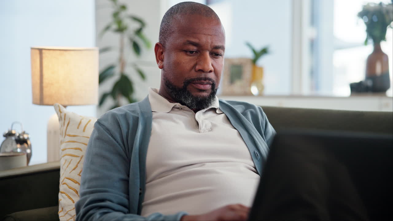 Man Working on Laptop at Home