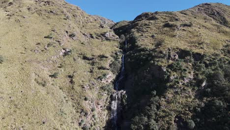 tall waterfall cascading down a steep mountain