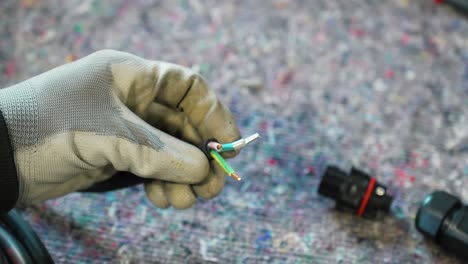 Close-up-slow-motion-shot-of-an-electrical-engineer-stripping-the-outer-aspect-of-the-wire