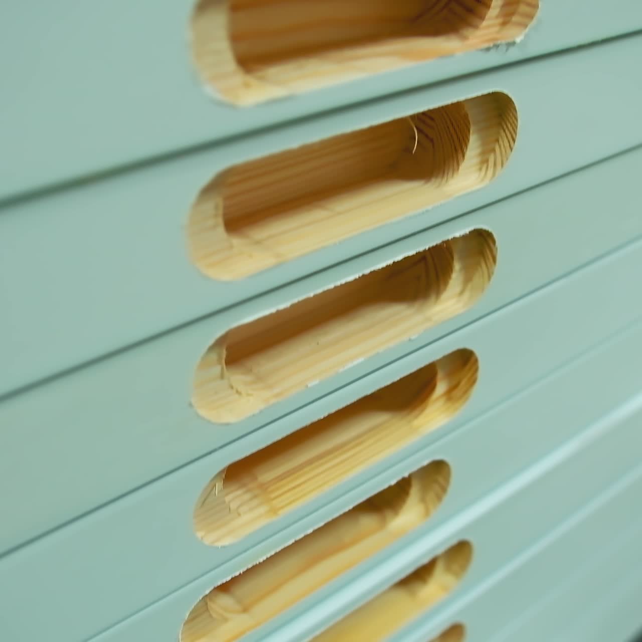 Manufacturing of doors. Pile of wooden doors in workshop. Holes in boards during furniture production. Door industry.