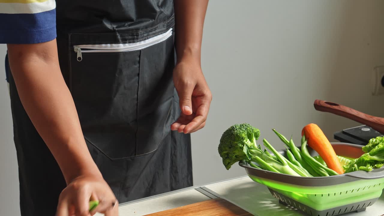 Person preparing fresh vegetables in a kitchen