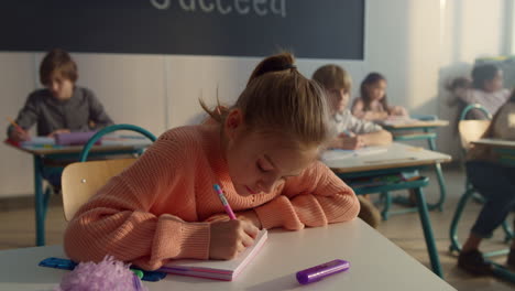 schoolgirl making notes in notebook. smart student writing in exercise book