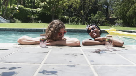 diverse couple, a young caucasian man and an african american woman, enjoy poolside leisure