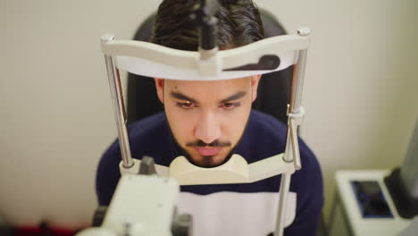 male patient at the optometrist doing a retina eye