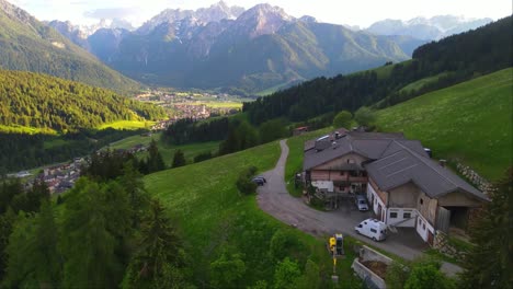 drone follows a white camper van through a winding mountain road around the alps_italy