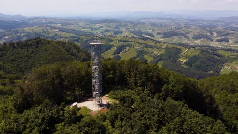 telecommunication tower on hill and podcertek rural slovenian landscape, sunny day