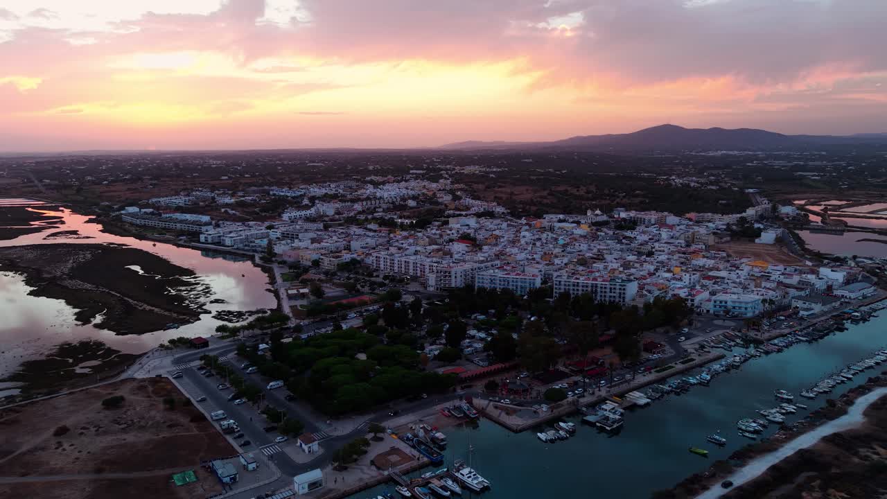 Aerial shot around Fuseta fishing village at sunset in Ria Formosa natural reserve near Faro in the Algarve region, Portugal