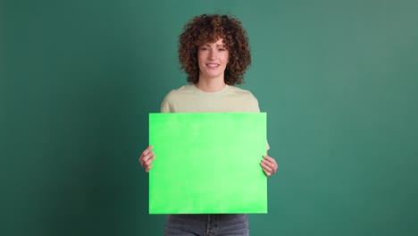 happy woman holding chroma sign banner in green background