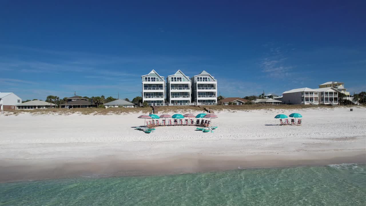 Beachfront Luxury Homes With Beach Umbrellas And Chairs On White Sand At Summer. Panama City Beach In Florida. wide drone shot