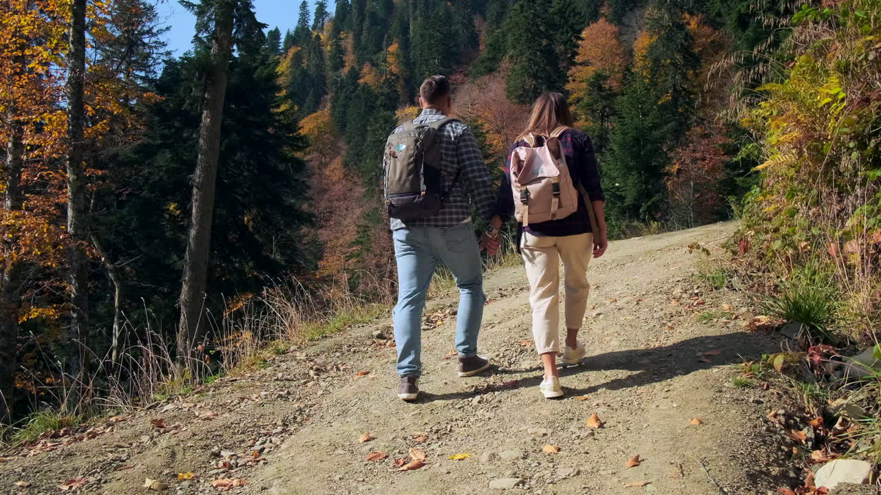 Una coppia che fa un'escursione nella foresta d'autunno